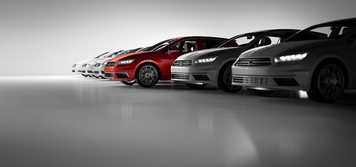 Compact cars fleet in the studio garage. A red one standing out. Choosing new car concept. Generic and brandless yet contemporary and elegant look. 3D illustration